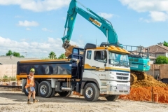 Scarbro Civil Contractors Excavator Loading Truck